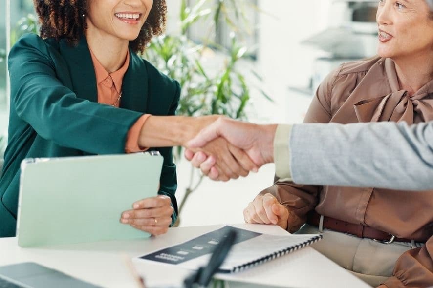 Professionals shaking hands after forming a partnership